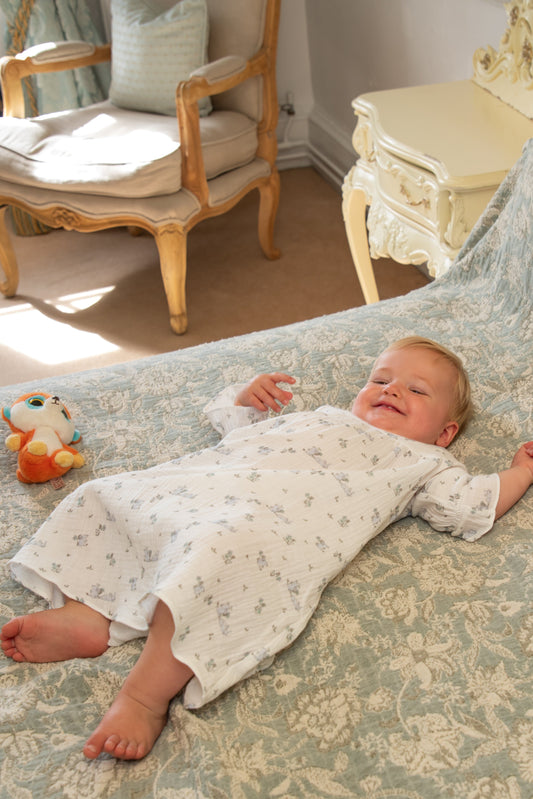 Baby wearing Harriet Jane London The Meadow white nightie in organic muslin cotton bunny print unisex girls boys